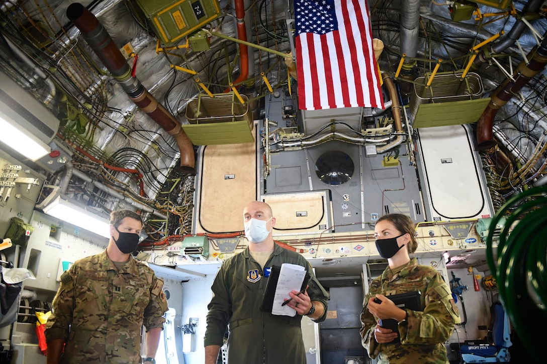 A group of 932nd Aeromedical Evacuation Squadron (AES) members prepare equipment and checklist on a visiting C-17 aircraft September 27, 2020, Scott Air Force Base, Ill. Waiting for final instructions before take off are Capt. Stan Belew, Maj. Joseph Hodges, and 1st Lt. Courtney Shockley. The 932nd Airlift Wing worked improving and refining hands on skills at the reserve unit, and included members of the 131st Medical Group, from Missouri, and 445th Airlift Wing from Ohio. Airmen worked together on in depth mission preparation and first aid skills. Simulated patients were moved safely on to a waiting vehicle.The highly-packed training was designed to prepare Airmen for any future aeromedical missions. (U.S. Air Force photo by Lt. Col. Stan Paregien)