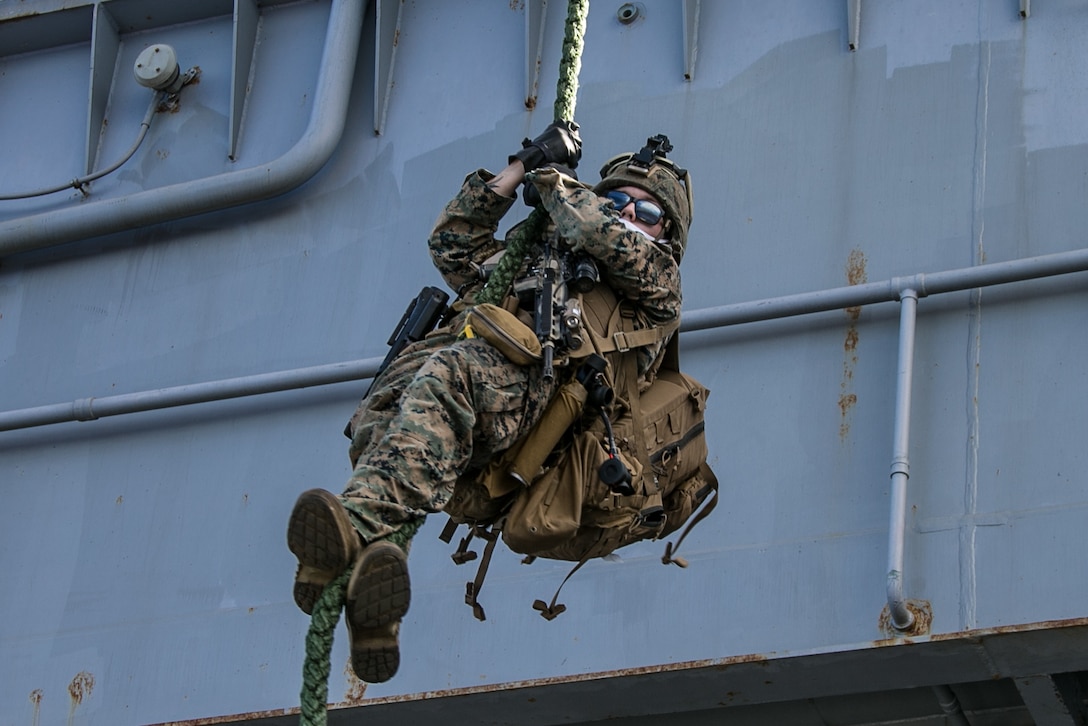 A U.S. Marine fast ropes out of an MV-22B Osprey aboard amphibious assault ship USS America (LHA 6), Sept. 23.