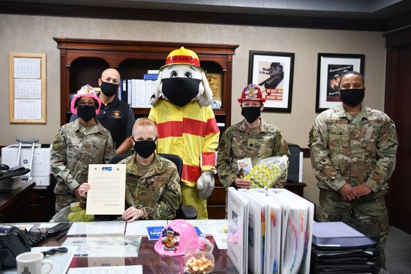 Col. Anita Feugate Opperman, 341st Missile Wing commander, poses for a photo with Sparky the Fire Dog and fellow leadership, officially recognizing Fire Prevention Week with a proclamation signing Sept. 29, 2020, at Malmstrom Air Force Base, Mont.