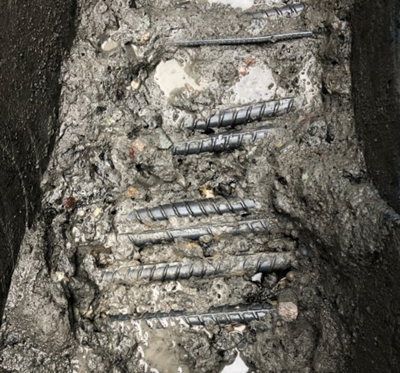 A look inside the the cracks and damage to the concrete sill exposed and broken rebar inside the navigation lock's concrete.