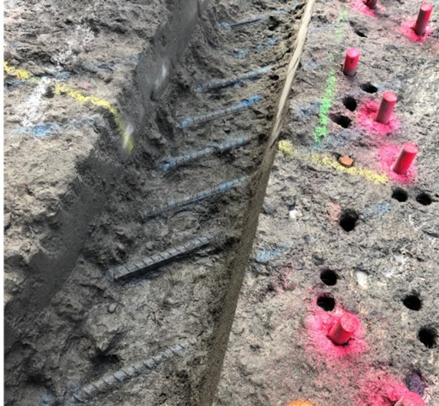 Rebar reinforcement is visible through cracked concrete.