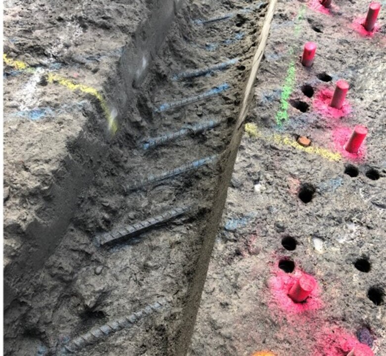 Rebar reinforcement is visible through cracked concrete.