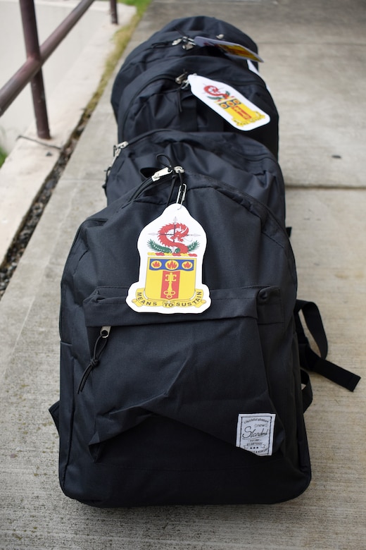 Backpacks lined in a row ready for delivery.