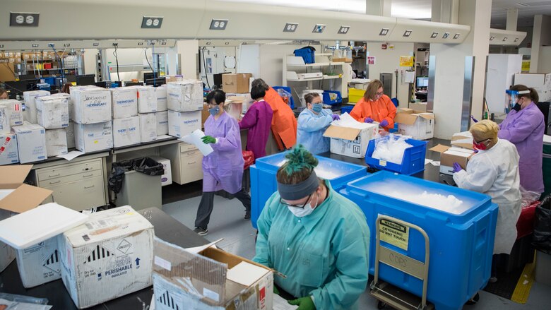 Medical laboratory technicians in the United States Air Force School of Aerospace Medicine’s Epidemiology Laboratory unload new shipments of potential COVID-19 samples sent from military treatment facilities around the world June 2, 2020. The Epi Lab is the sole clinical reference lab in the Air Force, and USAFSAM is part of AFRL’s 711th Human Performance Wing headquartered at Wright-Patterson Air Force Base in Dayton, Ohio. (U.S. Air Force photo by Richard Eldridge)