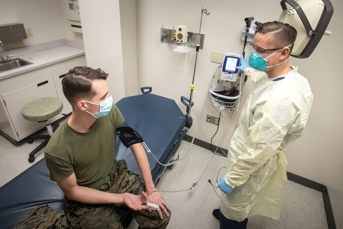 A U.S. Navy Hospitalman demonstrates intake procedures of possible Coronavirus patients on a U.S. Marine, Marine Corps Air Station Cherry Point, N.C., Aug. 6.