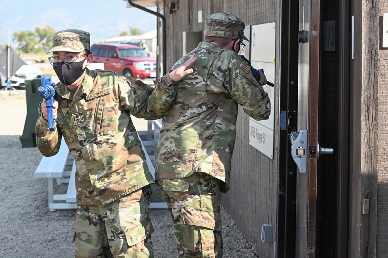 Airman 1st Class Aydenkenshin Bais, 388th Aircraft Maintenance Squadron (left), backs up his partner while searching a room during an expeditionary active shooter training course Sept. 25, 2020, at Hill Air Force Base, Utah. The course is one part of the Hill Expeditionary Airman Readiness Training program, or HEART, where first-term Airmen are trained with basic readiness skills. (U.S. Air Force photo by Cynthia Griggs)