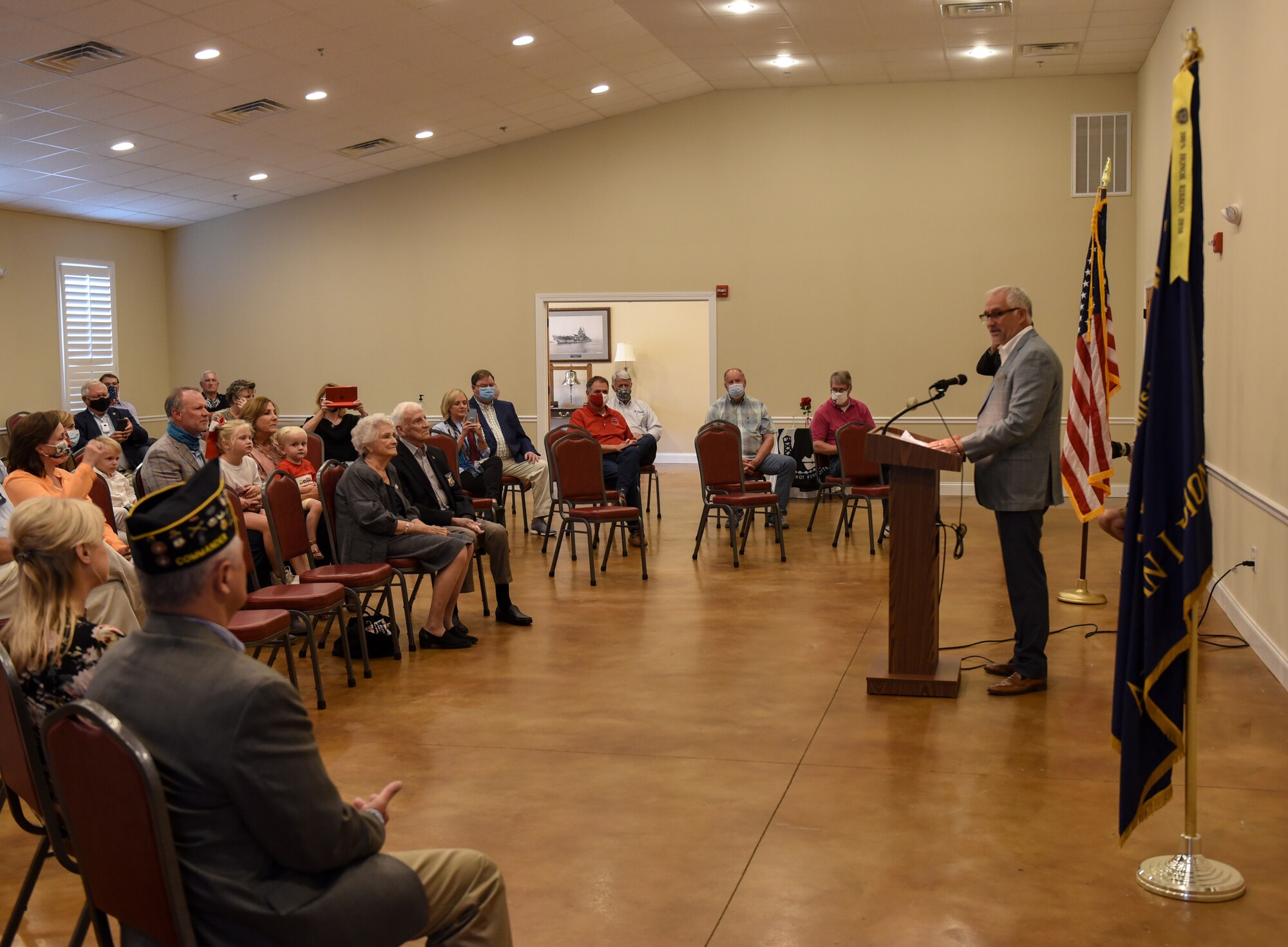 Ret. Col. Carlyle “Smitty” Harris, former prisoner of war, and his wife Louise Harris, sit as their son, Lyle Harris, gives a speech at Harris’ room dedication ceremony on September 18, 2020, in Tupelo, Miss. Harris’ son was born shortly after Harris was captured and he did not see his son until nearly eight years later. (U.S. Air Force photo by Airman 1st Class Davis Donaldson)