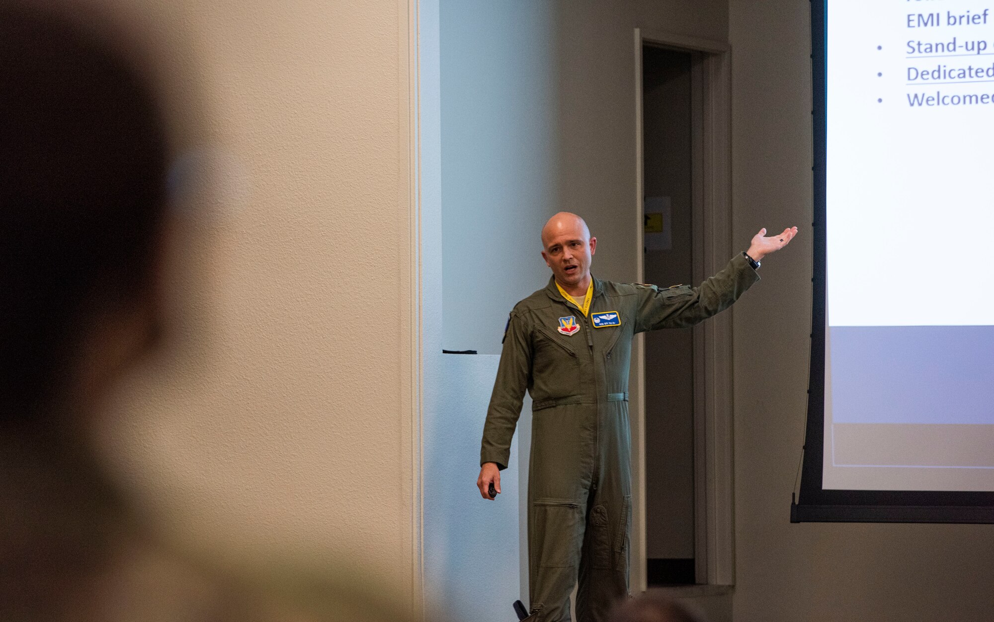 Lt. Col. Robert points to a powerpoint while speaking to the Airmen of the 15th Attack Squadron.