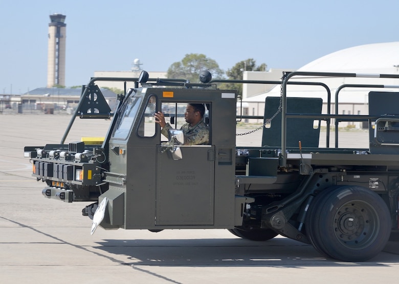 Man operates cargo loading vehicle