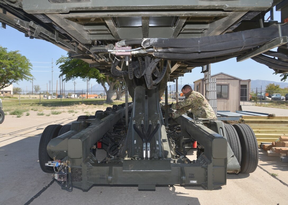Man removes maintenance support from vehicle