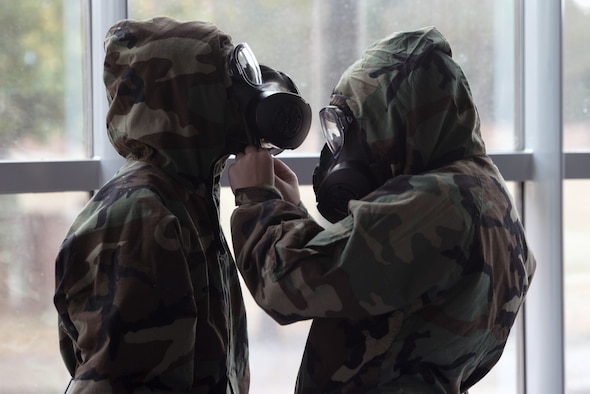 Two chemical, biological, radiological, and nuclear defense course students perform buddy checks, Ramstein Air Base, Germany, Sept. 24, 2020.