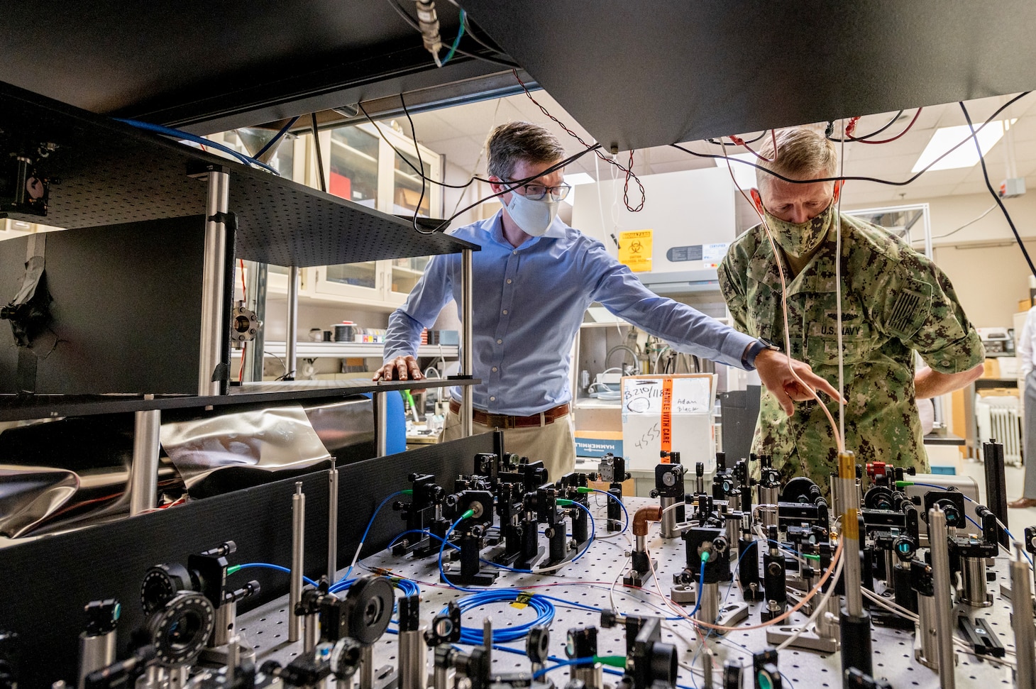 Jonathan Kwolek, a U.S. Naval Research Laboratory research physicist, shows an atom interferometer to Chief of Naval Research Rear Adm. Lorin Selby Sept. 14, 2020, at Naval Research Labratory (NRL) facilities in Washington, D.C.