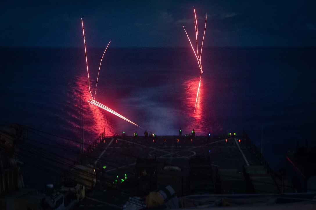 U.S. Marines fire an M240B medium machine gun during a night shoot aboard dock landing ship USS Germantown (LSD 42), Sept. 27.
