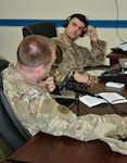 Chief Warrant Officer 3 Jonathon Molik, Task Force Spartan-42nd Infantry Division, Intelligence Analyst Control Element officer in charge, and Staff Sgt. William Simone, Task Force Spartan-42nd Infantry Division, Military Intelligence Fusion noncommissioned officer in charge, record their weekly podcast.