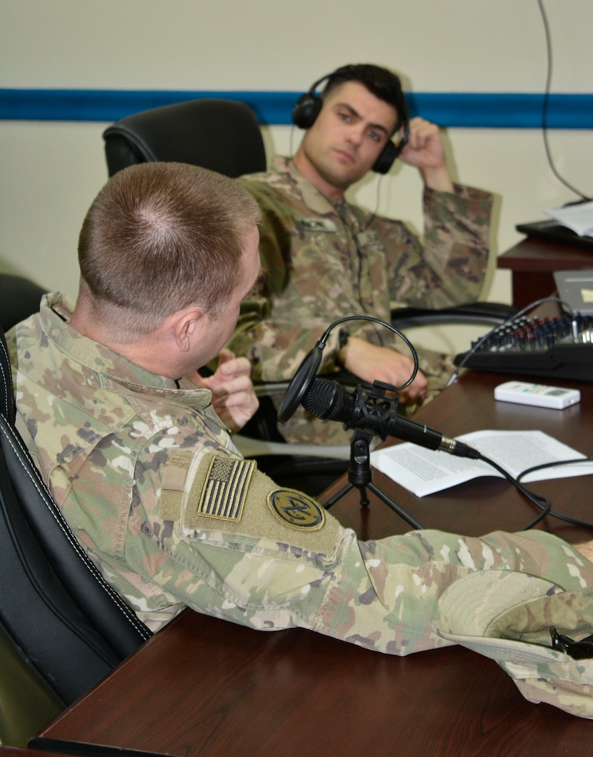 Chief Warrant Officer 3 Jonathon Molik, Task Force Spartan-42nd Infantry Division, Intelligence Analyst Control Element officer in charge, and Staff Sgt. William Simone, Task Force Spartan-42nd Infantry Division, Military Intelligence Fusion noncommissioned officer in charge, record their weekly podcast.