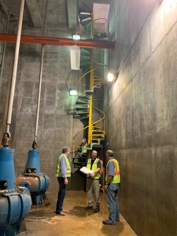 Workers discuss coming improvements inside the 5th Street Pump Station in Kansas City, Kansas September 29, 2020.