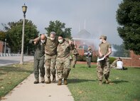 U.S. Air Force Airmen carry another Airman