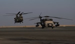 A CH-47 Chinook helicopter, operated by Soldiers with Bravo Company, 2-104th General Support Aviation Battalion, 28th Expeditionary Combat Aviation Brigade, takes off from an airfield for a local area orientation flight in the 28th ECAB's area of operations after arriving in the Middle East. These flights ensure 28th ECAB aircrews are properly acclimated and can conduct missions safely during the deployment.