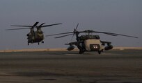 A CH-47 Chinook helicopter, operated by Soldiers with Bravo Company, 2-104th General Support Aviation Battalion, 28th Expeditionary Combat Aviation Brigade, takes off from an airfield for a local area orientation flight in the 28th ECAB's area of operations after arriving in the Middle East. These flights ensure 28th ECAB aircrews are properly acclimated and can conduct missions safely during the deployment.