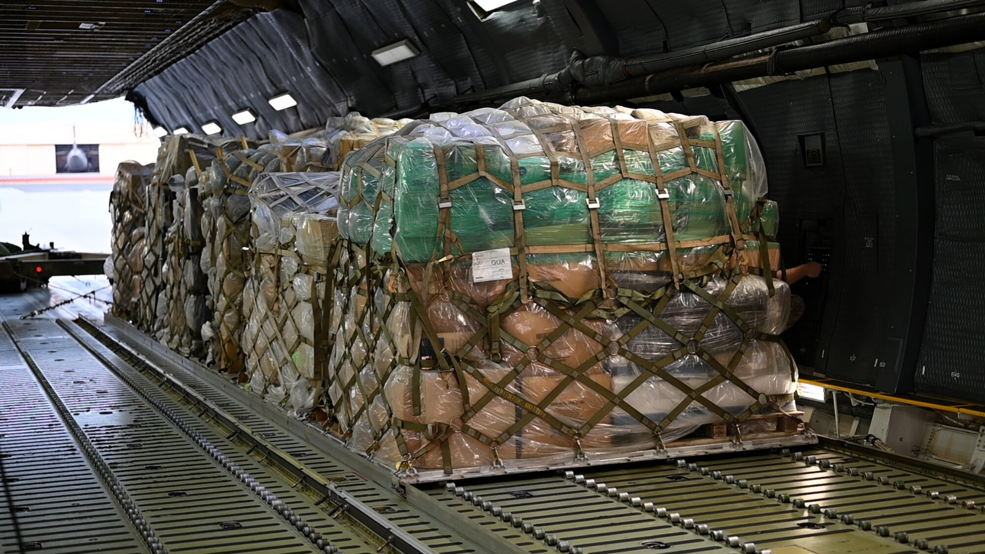 Photos of 22nd Airlift Squadron Airmen loading humanitarian aid at Travis AFB and delivering it to Guatemala.