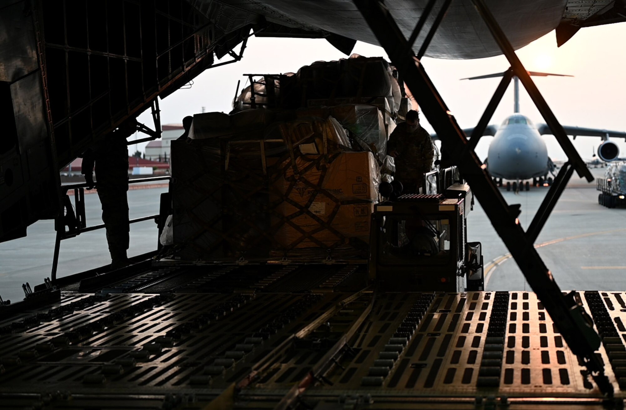 Photos of 22nd Airlift Squadron Airmen loading humanitarian aid at Travis AFB and delivering it to Guatemala.