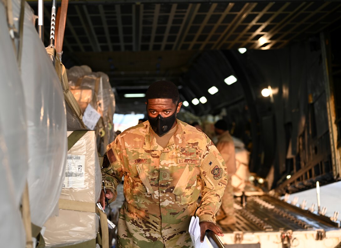 Photos of 22nd Airlift Squadron Airmen loading humanitarian aid at Travis AFB and delivering it to Guatemala.