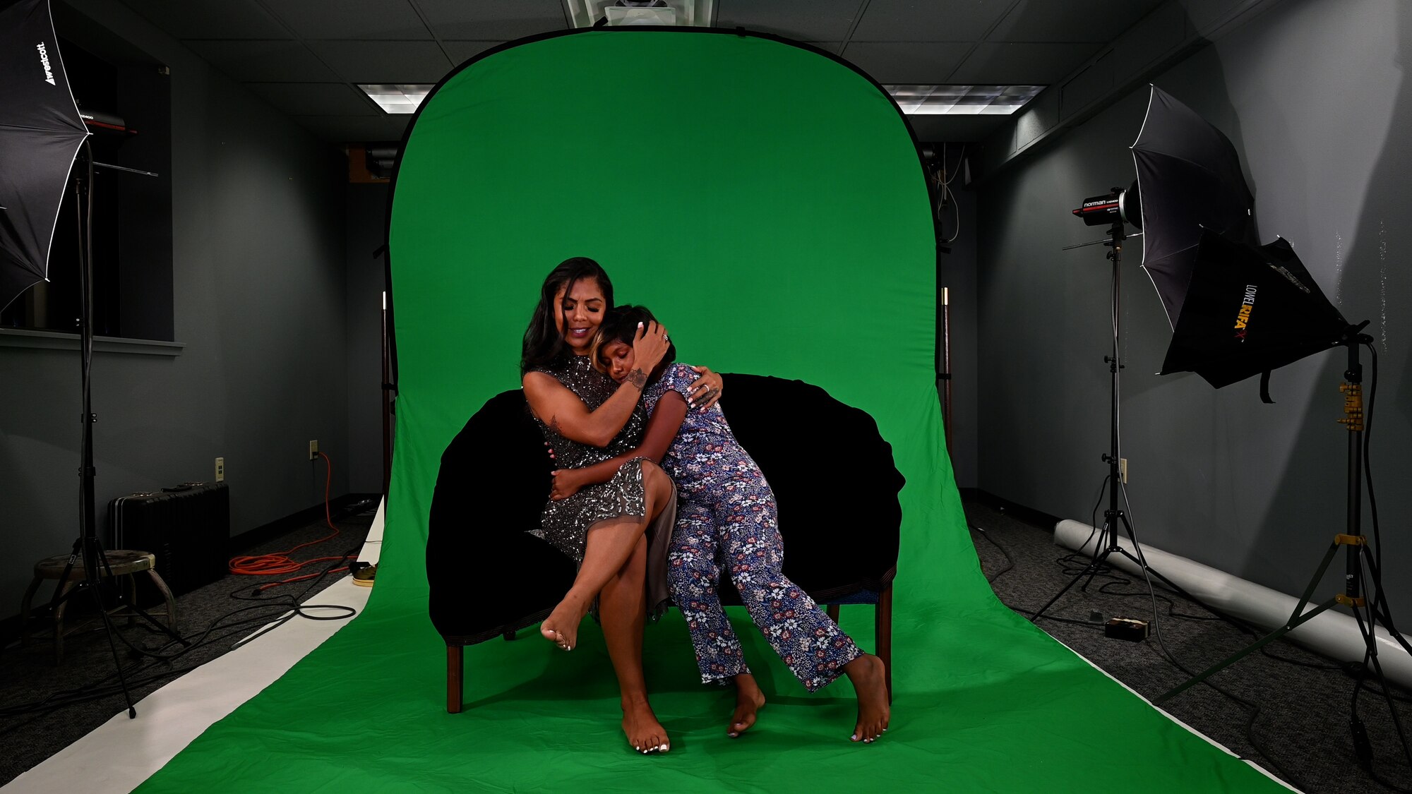 Airman and daughter perform a lip sync routine in front of a green screen