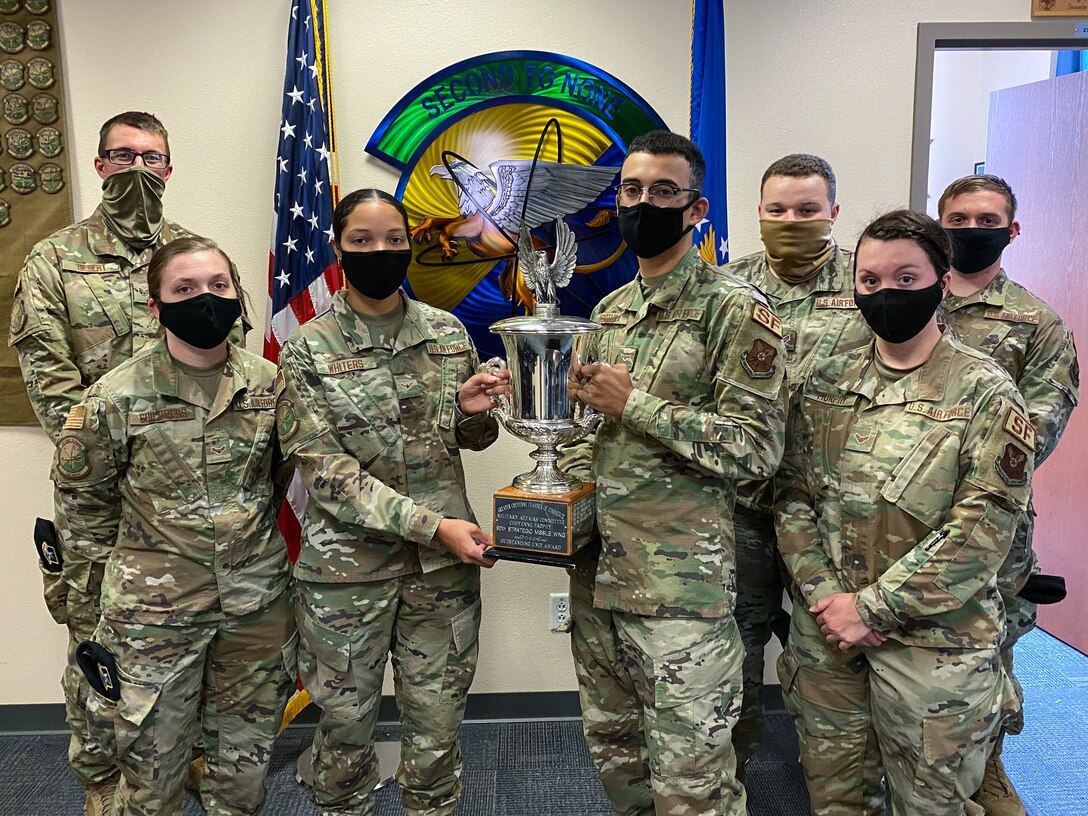 The 790th Missile Security Forces Squadron Airmen pose for photos with the Cheyenne Trophy on F.E. Warren Air Force Base, Wyoming, Sept. 10, 2020. The Greater Cheyenne Chamber of Commerce recently presented the Military Affairs Committee’s Cheyenne Trophy to the 790th Missile Security Force Squadron for mission accomplishments, patriotism, off-duty volunteerism and community involvement resulting in a positive impact on the city of Cheyenne and its residents. (U.S. Air Force photos by Joseph Coslett)