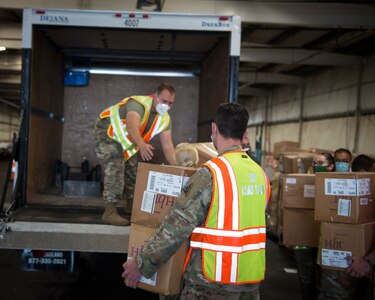 Soldiers and Airmen from the Connecticut National Guard load boxes of face masks into a vehicle at West Hartford Public Works, West Hartford, Connecticut, Sept. 30, 2020. The Connecticut National Guard is helping distribute 600,000 masks to school districts throughout the state.