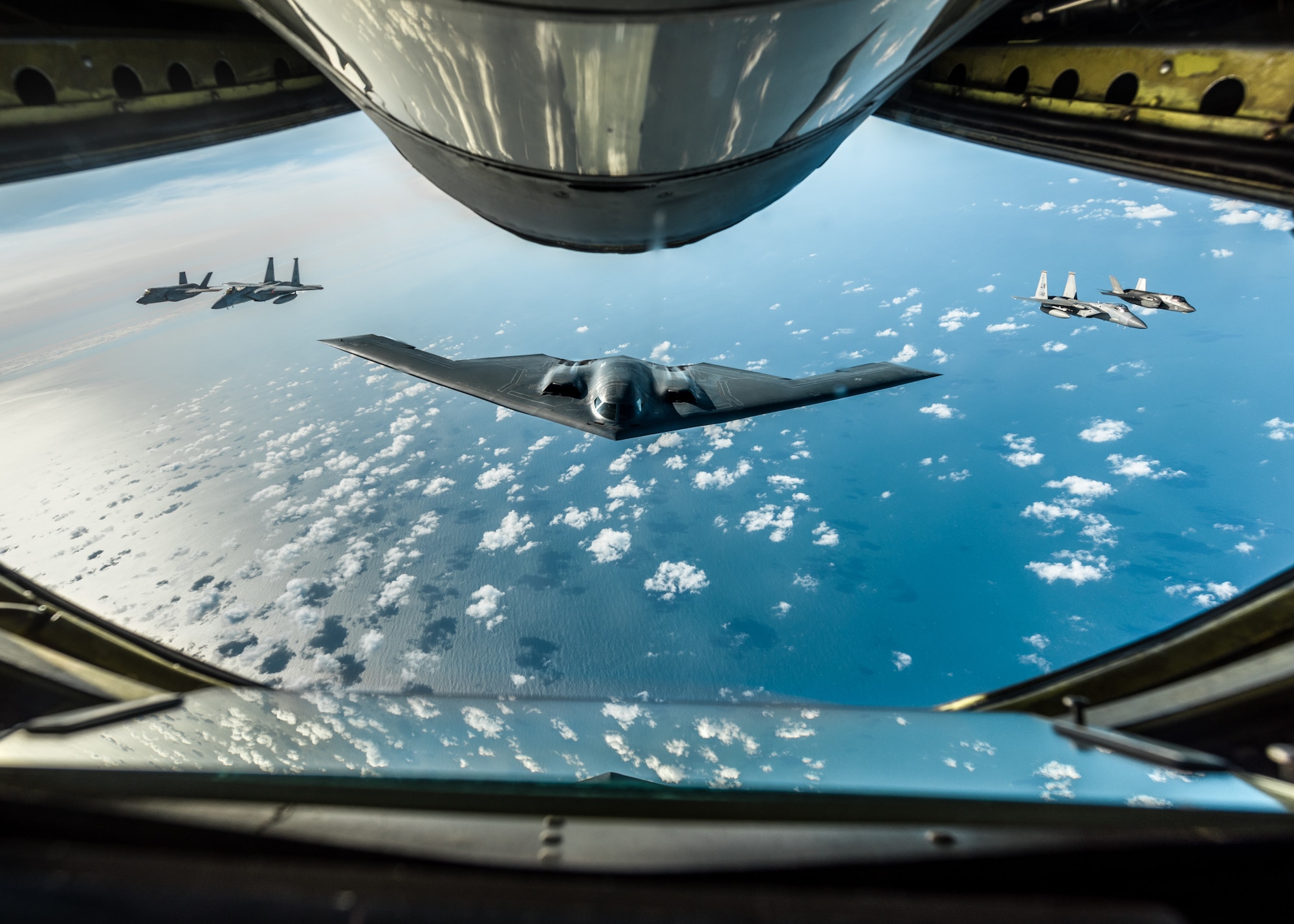 A B-2 Spirit Stealth Bomber, assigned to the 509th Bomb Wing at Whiteman Air Force Base, Missouri, two Royal Air Force F-35 Lightning IIs assigned to RAF Marham, England, and two F-15 Eagles assigned to the 48th Fighter Wing at RAF Lakenheath, England, fly in formation behind a KC-135 Stratotanker, assigned to RAF Mildenhall, England, during a training mission for Bomber Task Force Europe on September 16, 2019. Three B-2 bombers, Airmen and support equipment from Whiteman AFB deployed to RAF Fairford, England, as part of Bomber Task Force Europe. These multinational missions enhance our professional relationships and improves overall coordination with allies and partner militaries during times of crisis. (U.S. Air Force photo by Senior Airman Thomas Barley)