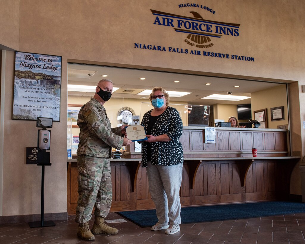Wing commander presents Edith Fose with certificate of service