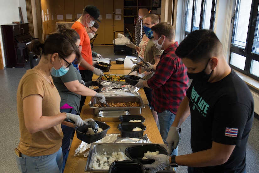 Volunteers assemble meals for delivery to those in need.