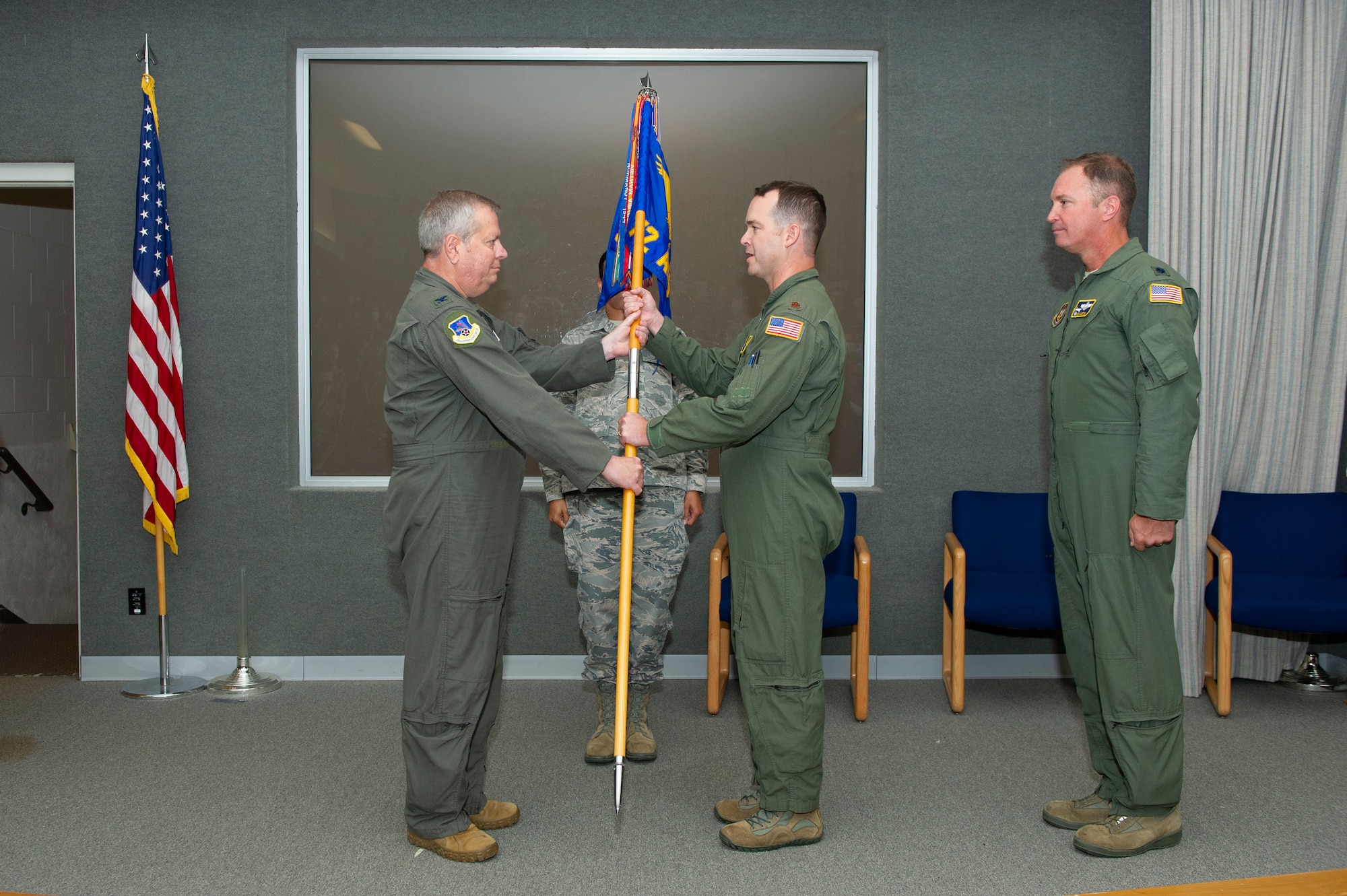 U.S. Air Force Col. Brian Hollis, 434th Operations Group commander, hands the 72nd Air Refueling Squadron guidon to Maj. Derek Portlock, 72nd ARS incoming commander, during a change of command ceremony at Grissom Air Reserve base, Indiana, Sept. 12, 2020. Portlock received command of the 72nd ARS from Lt. Col. Joe Austin, 72nd ARS outgoing commander. (U.S. Air Force photo by Staff Sgt. Michael Hunsaker)