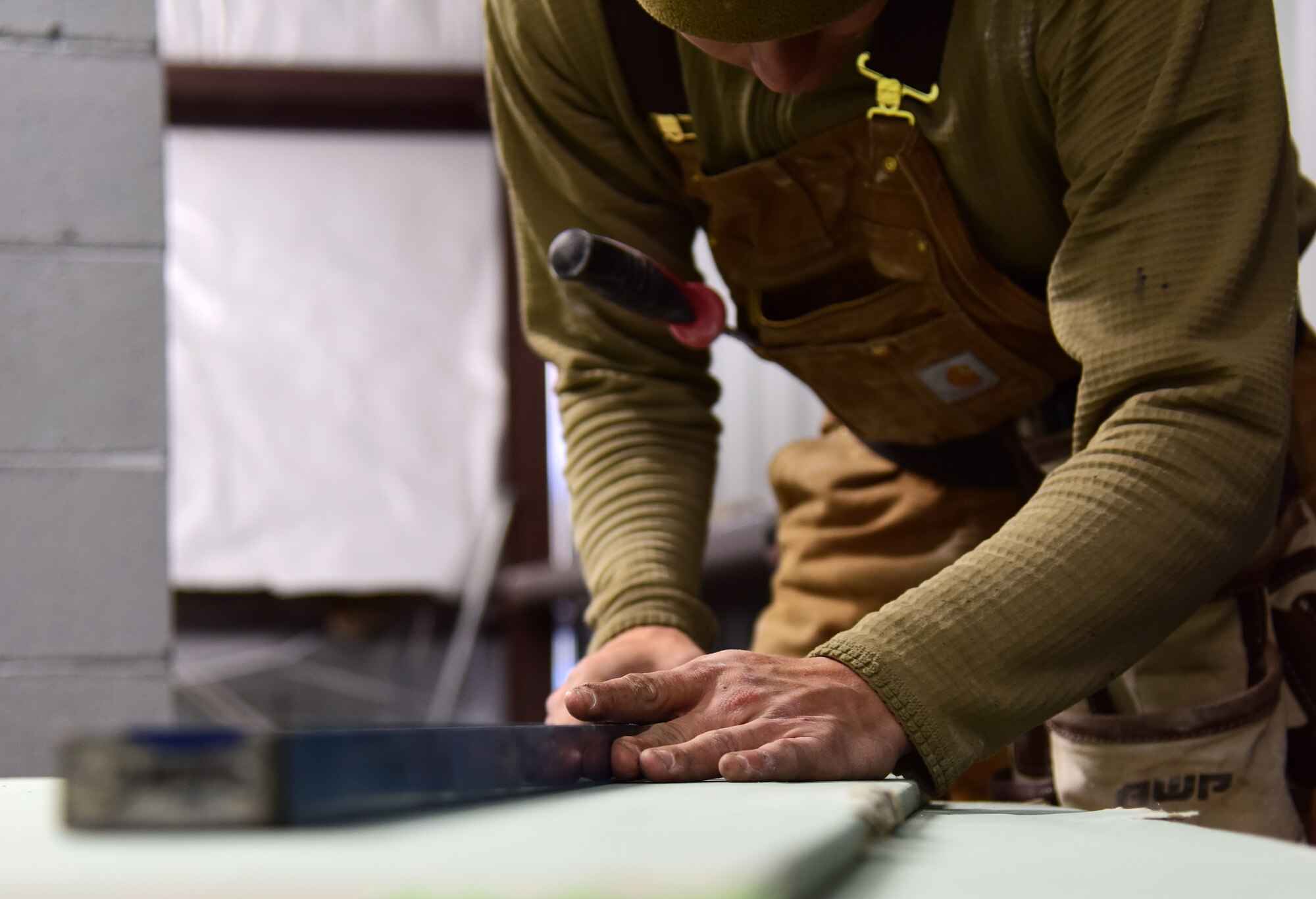 U.S. Air Force Staff Sgt. James Ori, a 554th Rapid Engineer Deployable Heavy Operational Repair Squadron Engineers (RED HORSE) structural craftsman, cuts off a piece of drywall at Eielson Air Force Base, Alaska, Sept. 10, 2020.