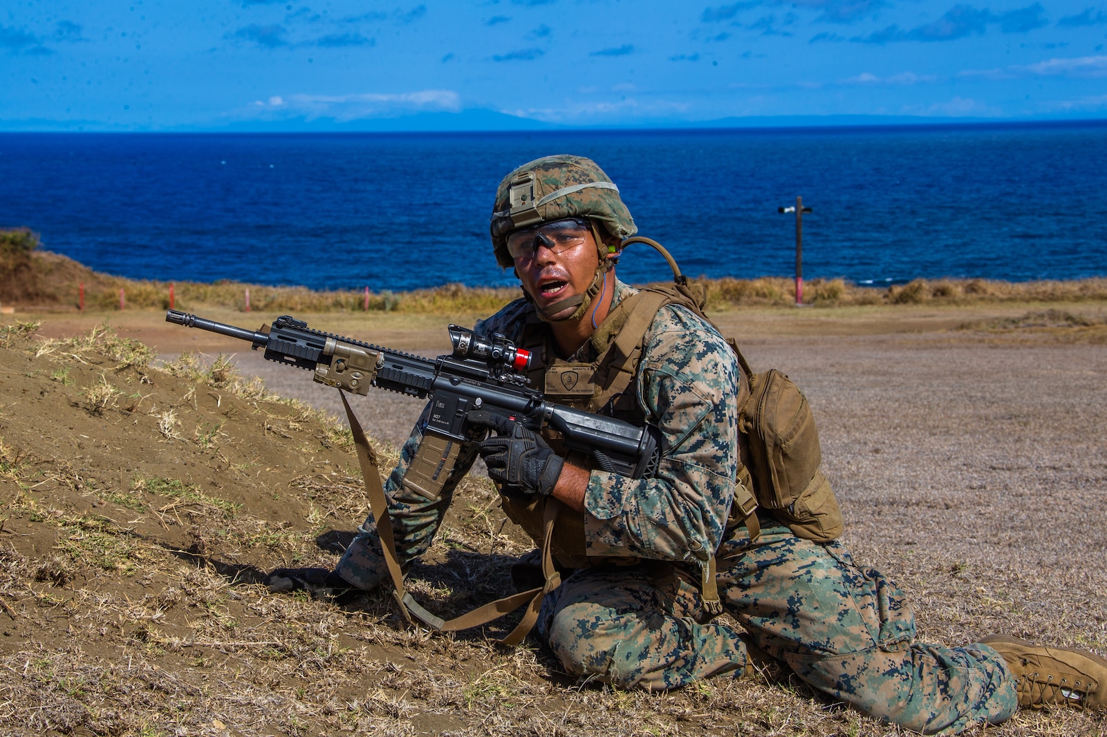 U.S. Marine Corps Lance Cpl. Santino Imparato, rifleman, Company E, 2nd Battalion, 3rd Marine Regiment, communicates with his troops while executing squad attacks during Exercise Bougainville I on Marine Corps Base Hawaii, Aug. 25, 2020. Bougainville I is designed to train and evaluate team leaders in small unit proficiency and increase the Battalion’s combat readiness. (U.S. Marine Corps photo by Cpl. Jacob Wilson)