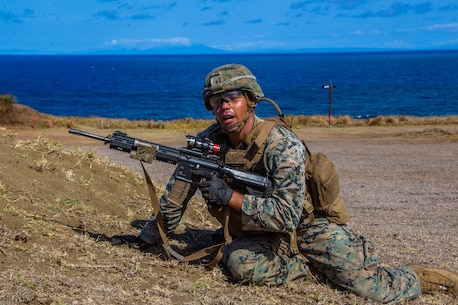 U.S. Marine Corps Lance Cpl. Santino Imparato, rifleman, Company E, 2nd Battalion, 3rd Marine Regiment, communicates with his troops while executing squad attacks during Exercise Bougainville I on Marine Corps Base Hawaii, Aug. 25, 2020. Bougainville I is designed to train and evaluate team leaders in small unit proficiency and increase the Battalion’s combat readiness. (U.S. Marine Corps photo by Cpl. Jacob Wilson)