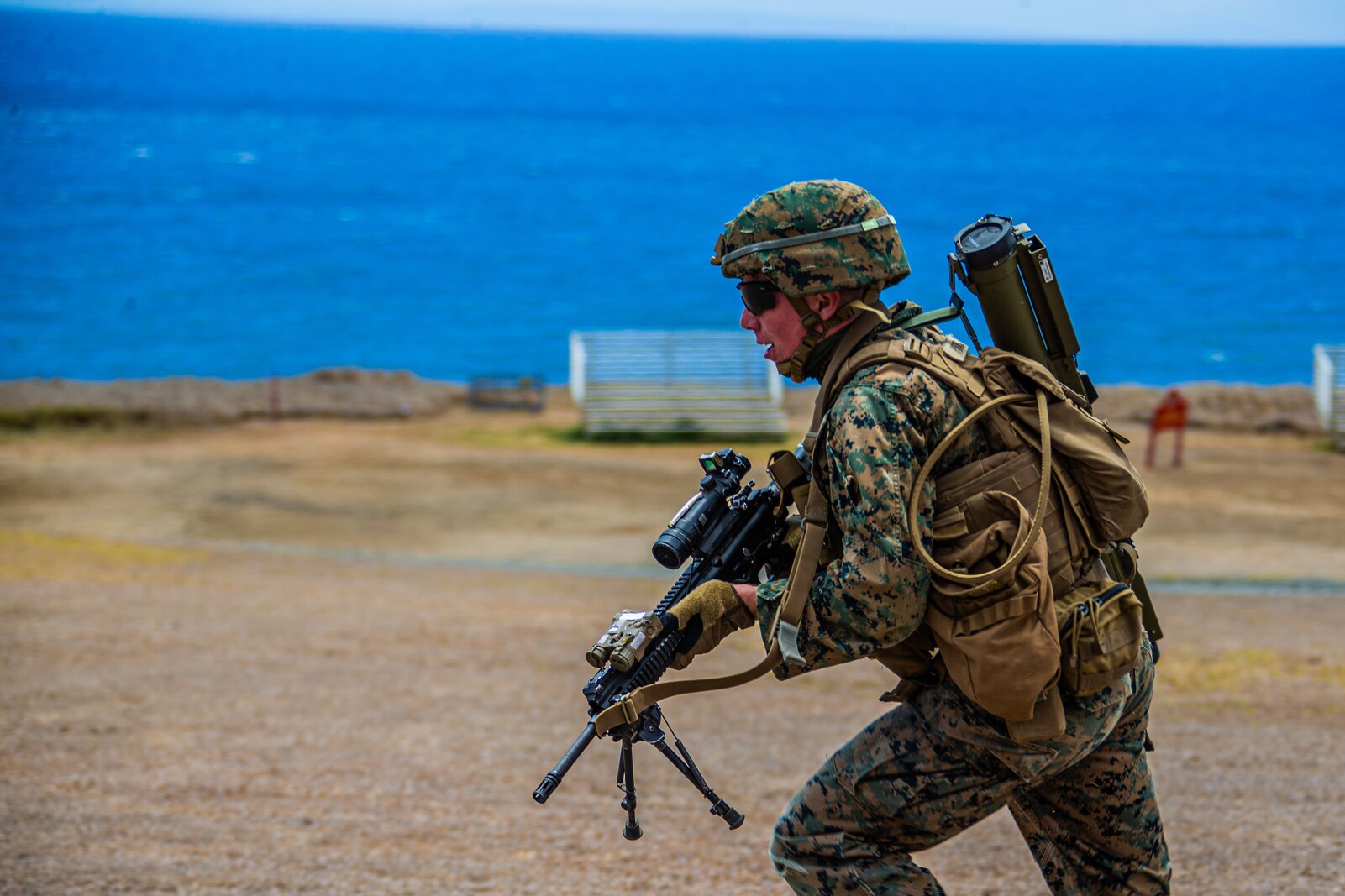 U.S. Marine Corps Lance Cpl. Konner Pontius, rifleman, Company E, 2nd Battalion, 3rd Marine Regiment, advances down range while executing squad attacks during Exercise Bougainville I on Marine Corps Base Hawaii, Aug. 25, 2020. Bougainville I is designed to train and evaluate team leaders in small unit proficiency and increase the Battalion’s combat readiness. (U.S. Marine Corps photo by Cpl. Jacob Wilson)