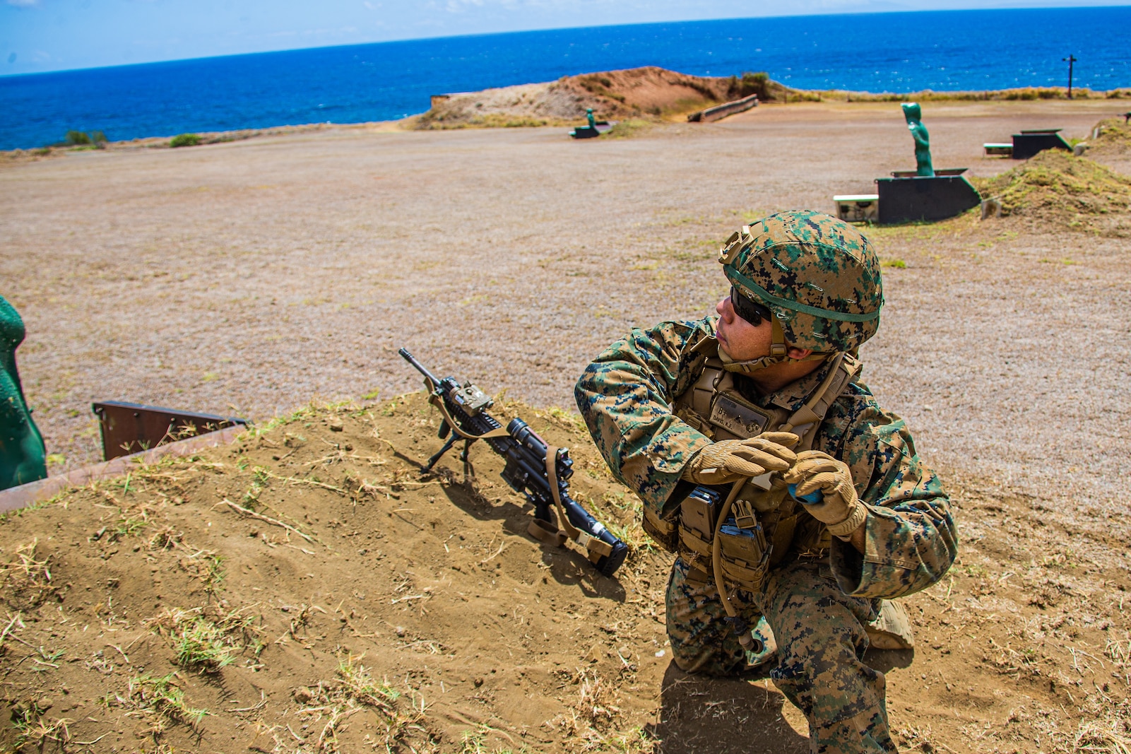 U.S. Marine Corps Lance Cpl. Aaron Davis, rifleman, Company E, 2nd Battalion, 3rd Marine Regiment, throws a training grenade while executing squad attacks during Exercise Bougainville I on Marine Corps Base Hawaii, Aug. 25, 2020. Bougainville I is designed to train and evaluate team leaders in small unit proficiency and increase the Battalion’s combat readiness. (U.S. Marine Corps photo by Cpl. Jacob Wilson)