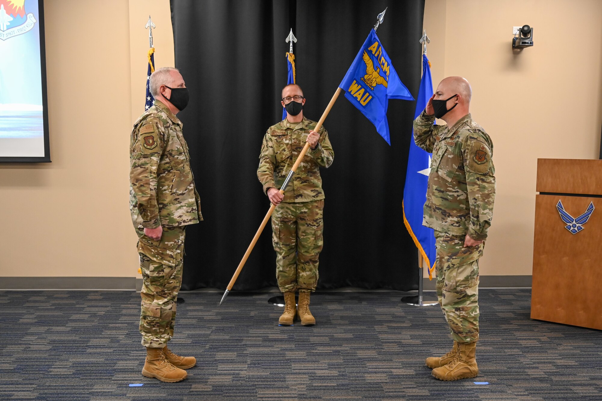 Col. Owen Stephens, F-22 Program Director, Fighters and Advanced Aircraft Directorate, Air Force Life Cycle Management Center (right), salutes Brig. Gen. Dale White, Executive Officer, Fighters and Advanced Aircraft, AFLCMC, at the F-22 Program Office Transfer Ceremony.