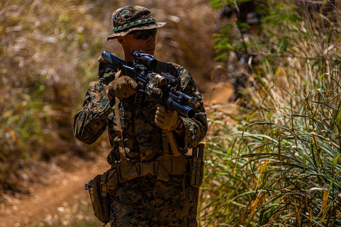 A U.S. Marine with Company F, 2nd Battalion, 3rd Marine Regiment, observes his surroundings while executing improvised explosive device training during Exercise Bougainville I at Marine Corps Training Area Bellows, Hawaii, Aug. 26, 2020. Bougainville I is designed to train and evaluate team leaders in small unit proficiency and increase the Battalion’s combat readiness. (U.S. Marine Corps photo by Cpl. Jacob Wilson)