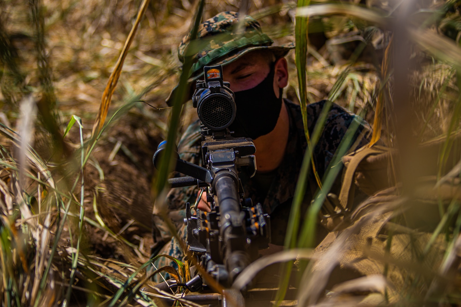 A U.S. Marine with Company F, 2nd Battalion, 3rd Marine Regiment, sights in with an M-240B machine gun while in the defense during Exercise Bougainville I at Marine Corps Training Area Bellows, Hawaii, Aug. 26, 2020. Bougainville I is designed to train and evaluate team leaders in small unit proficiency and increase the Battalion’s combat readiness. (U.S. Marine Corps photo by Cpl. Jacob Wilson)