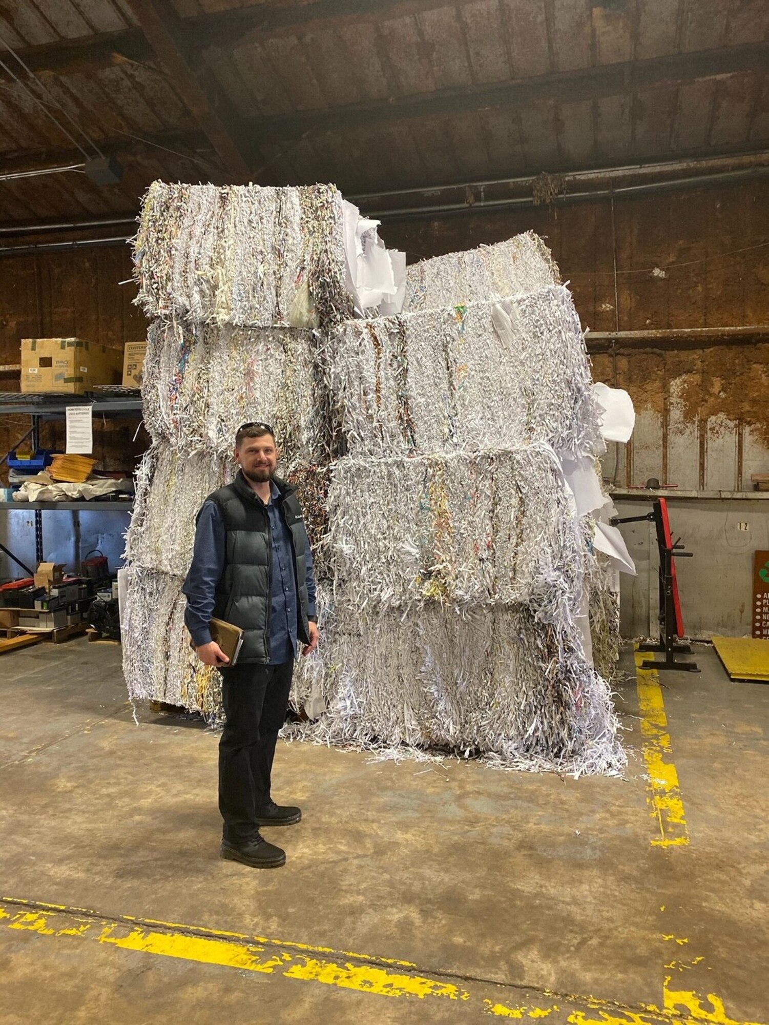 man stands in front of pile