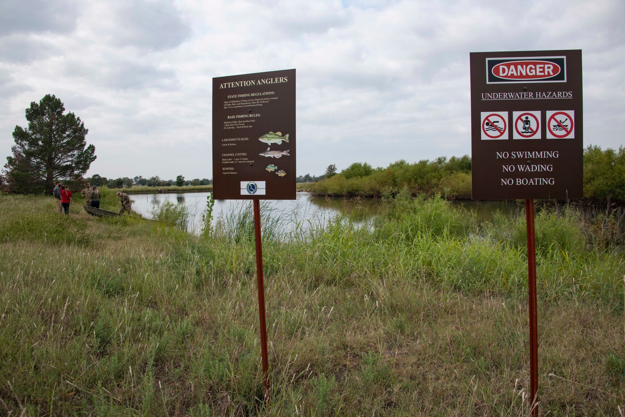 signs in front a pond