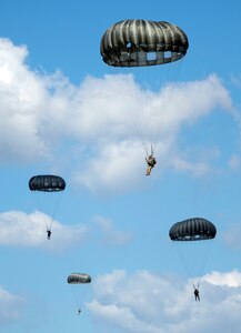 Texas National Guard Paratroopers from the 197th Special Troops Support Company, 36th Sustainment Brigade, jump out of a C-130 aircraft over Joint Base San Antonio-Camp Bullis Sept. 25. Soldiers assigned to airborne units must complete a parachute jump every three months to maintain their airborne status.