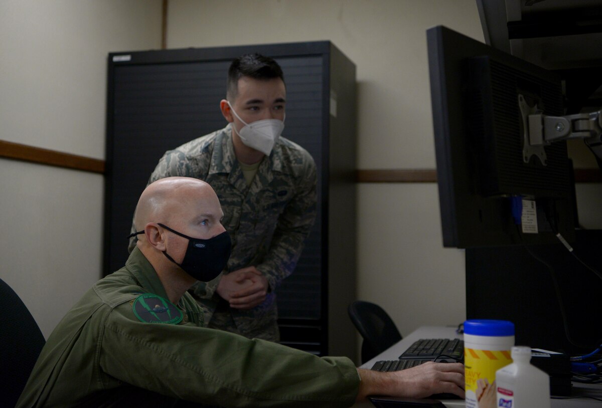 U.S. Air Force Airman 1st Class Jared Clark, a 354th Communications Squadron (CS) client systems technician, teaches Col. David Berkland, the 354th Fighter Wing (FW) commander, how to mitigate network vulnerabilities on Eielson Air Force Base, Alaska, Sept. 29, 2020. The 354th CS manages, operates, maintains and provides communications to support the 354th FW’s combat and support missions. (U.S. Air Force photo by Senior Airman Beaux Hebert)