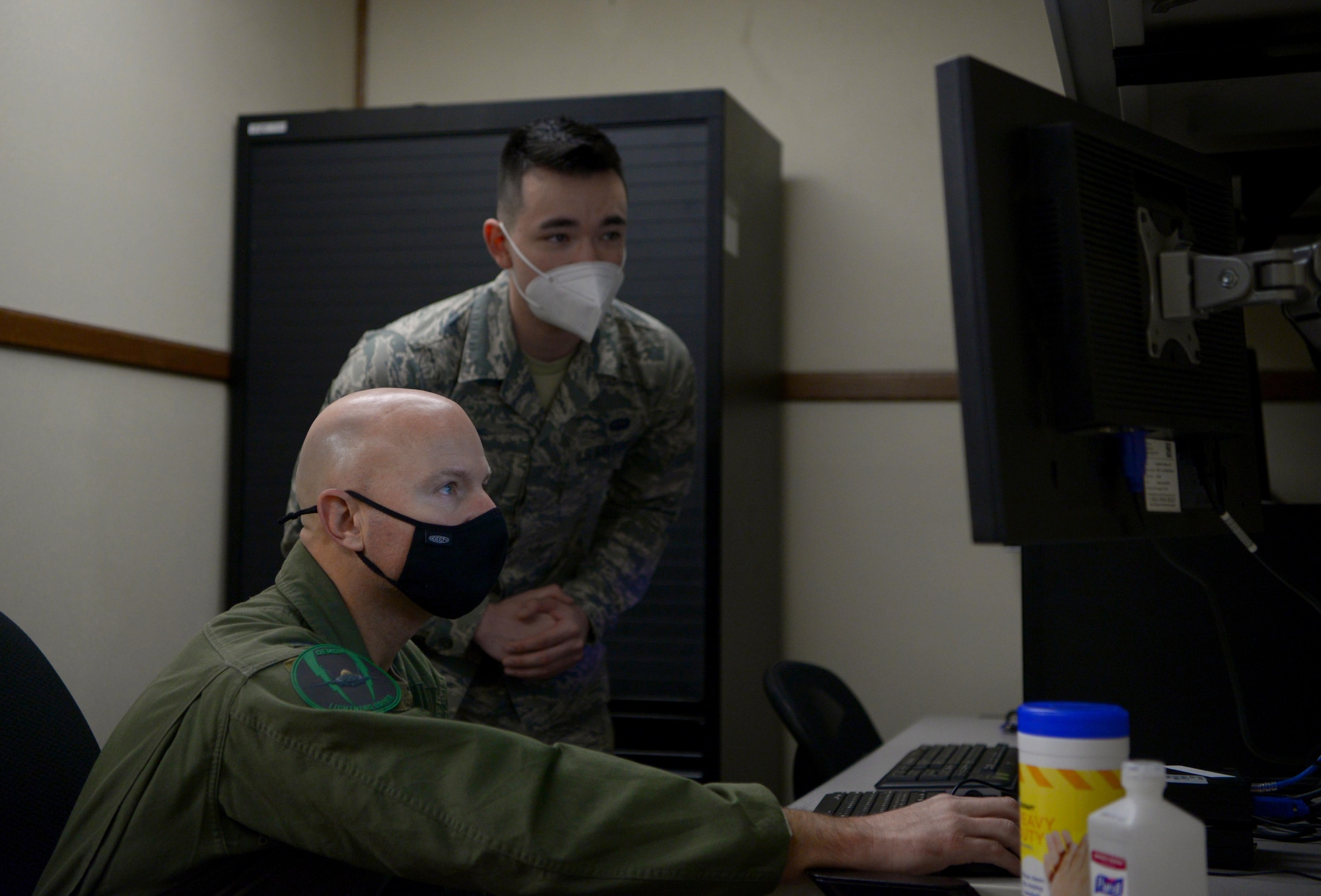U.S. Air Force Airman 1st Class Jared Clark, a 354th Communications Squadron (CS) client systems technician, teaches Col. David Berkland, the 354th Fighter Wing (FW) commander, how to mitigate network vulnerabilities on Eielson Air Force Base, Alaska, Sept. 29, 2020. The 354th CS manages, operates, maintains and provides communications to support the 354th FW’s combat and support missions. (U.S. Air Force photo by Senior Airman Beaux Hebert)