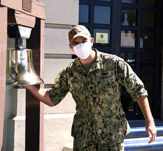 Cmdr. Nicholas Gamiz, commanding officer of Navy Recruiting District San Antonio, joined by NRD Sailors and support personnel, rings the mission bell at NRD headquarters at Joint Base San Antonio-Fort Sam Houston.