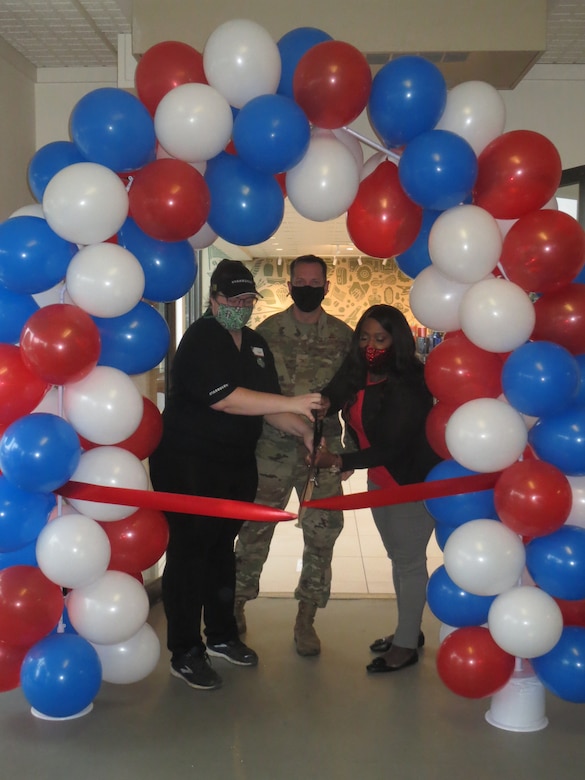 U.S. Air Force Col. Jason Delamater, 673d Mission Support Group commander, helps Chelsea Daneault, Starbucks manager and Charlyne Morganfield, Joint Base Elmendorf-Richardson Exchange general manager, cut the ribbon on the newly upgraded Ft. Richardson Starbucks, Sept. 28, 2020, at Joint Base Elmendorf-Richardson, Alaska.