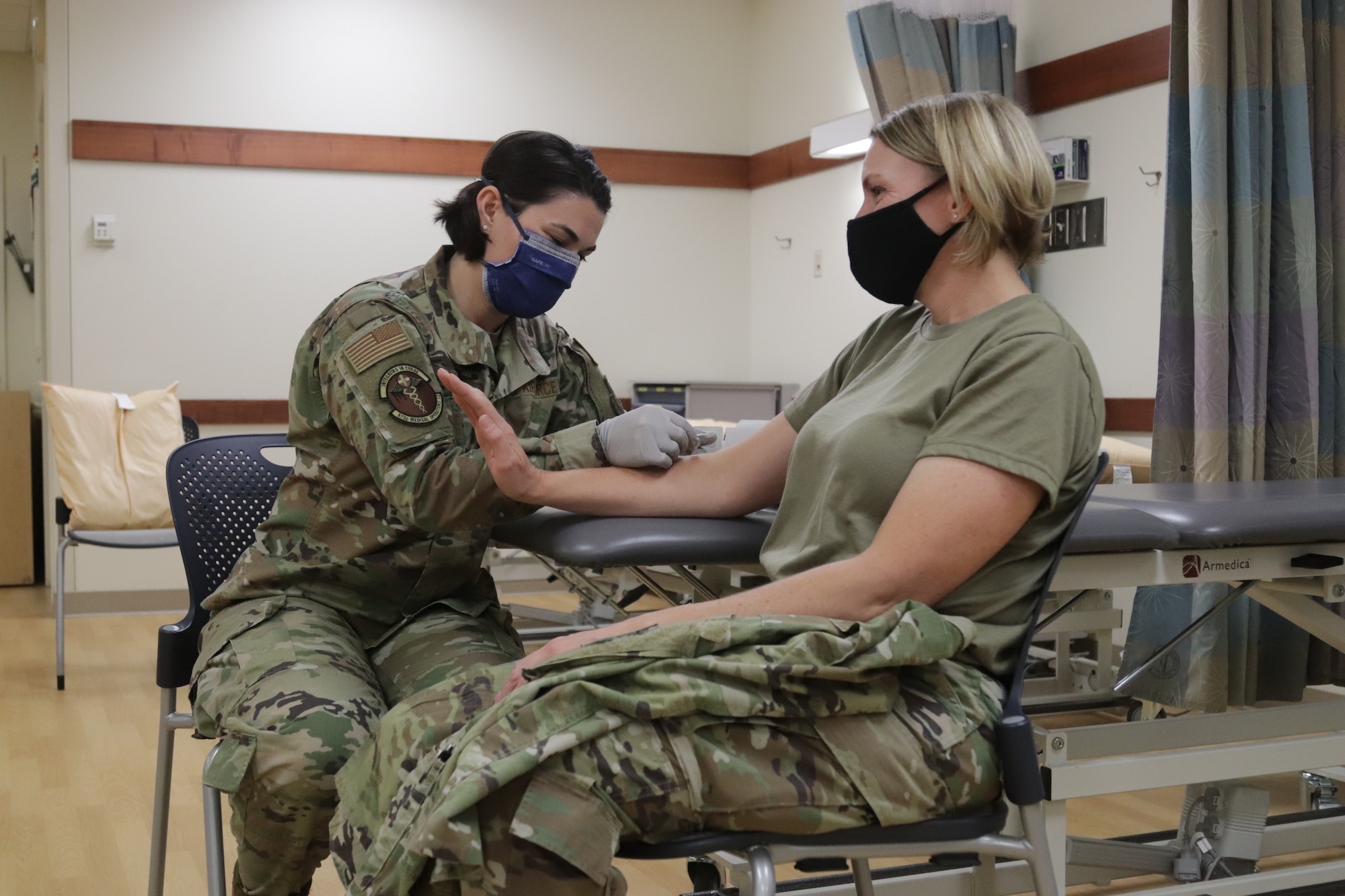 U.S. Air Force Capt. Jaime Briske, 673d Medical Operations Squadron staff physical therapist, inserts a dry needle into the arm of U.S. Air Force Col. Kirsten Aguilar, Joint Base Elmendorf-Richardson and 673d Air Base Wing commander, during a 673d MDOS immersion tour at JBER, Alaska, Sept. 24, 2020. Aguilar familiarized herself with the 673d MDOS and its role in supporting installation readiness after taking command of the installation on July 14, 2020. The 673d MDOS works to enhance the performance and overall health of JBER in order to ensure combat effectiveness. (U.S. Air Force photo by Capt. Orlando Cabigas)