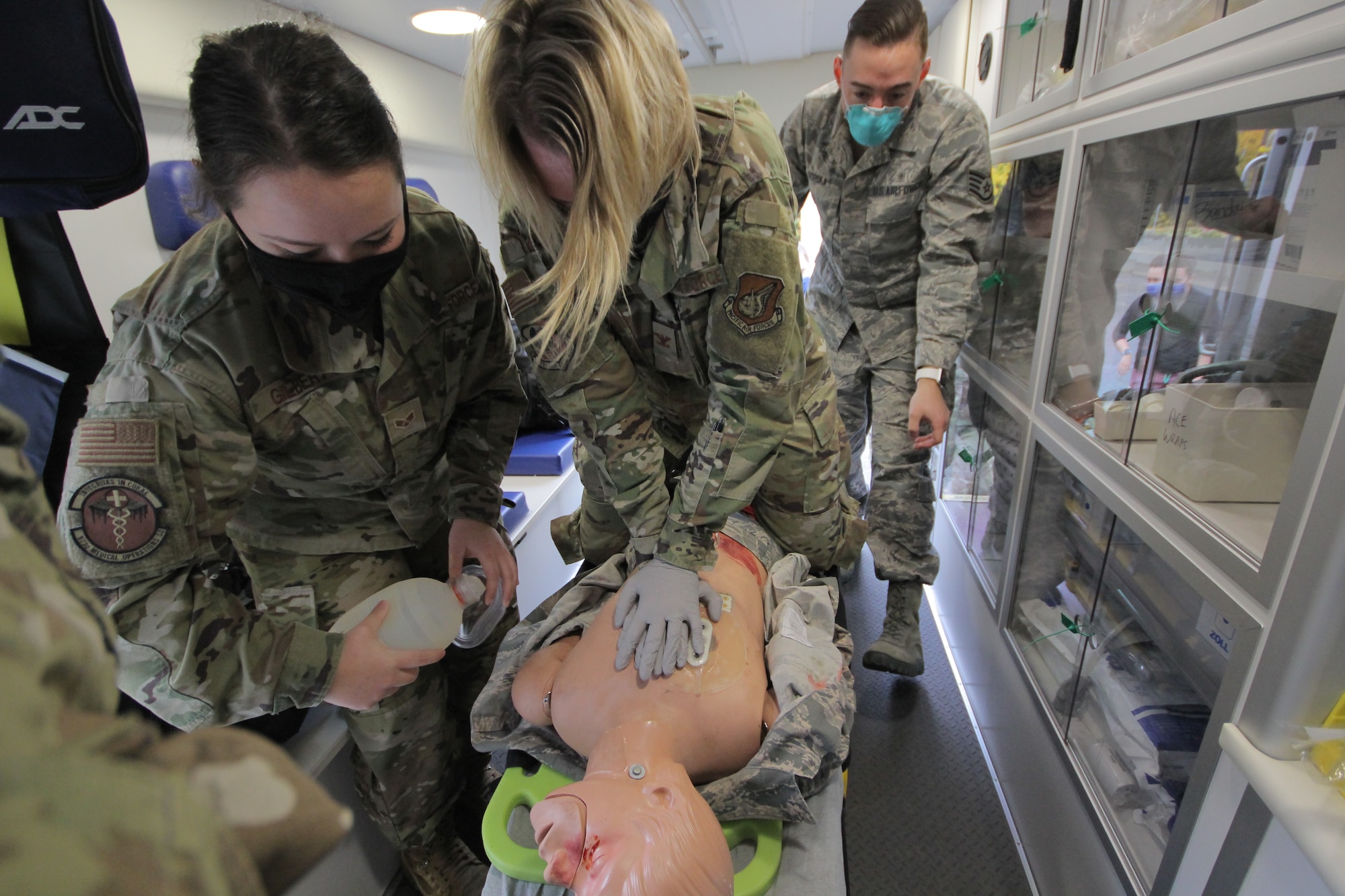 U.S. Air Force Col. Kirsten Aguilar, Joint Base Elmendorf-Richardson and 673d Air Base Wing commander, performs chest compressions for an exercise on a high fidelity manikin while U.S. Air Force Staff Sgt. Shawn Soroka, 673d Medical Operations Squadron paramedic and U.S. Air Force Senior Airman Ashton Gilbert, aerospace medical technician assist in completing life saving measures inside a moving ambulance during a 673d MDOS immersion tour at JBER, Alaska, Sept. 24, 2020. Aguilar familiarized herself with the 673d MDOS and its role in supporting installation readiness after taking command of the installation on July 14, 2020. The 673d MDOS works to enhance the performance and overall health of JBER in order to ensure combat effectiveness. (U.S. Air Force photo by Capt. Orlando Cabigas)